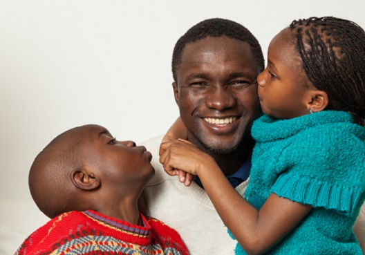 dad hugging his kids