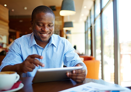 man looking at his tablet