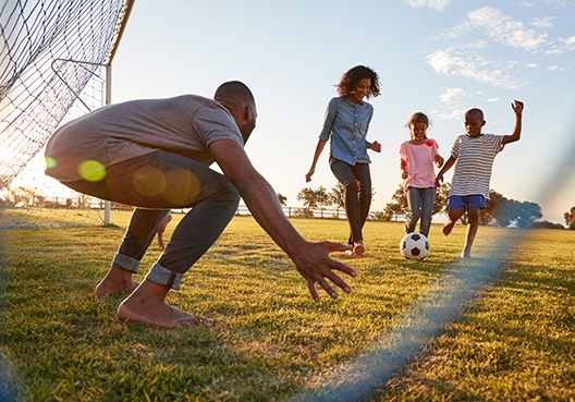 family having fun playing soccer