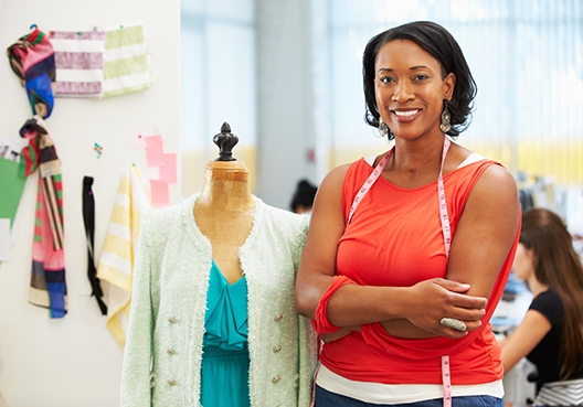 woman standing in a department store with her arms crossed