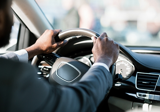 man with his hands on the steering wheel